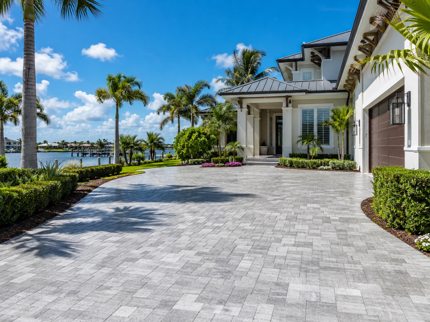 Illustrative driveway cleaning — interlocking stone paver drive at a waterfront home.