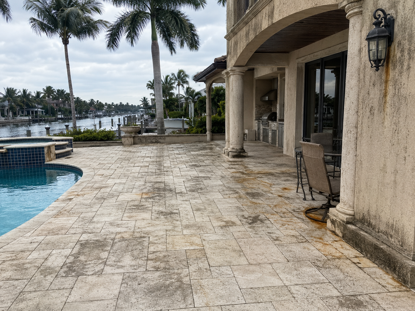 Before/after — patio mildew and rust staining cleared from stone pavers.