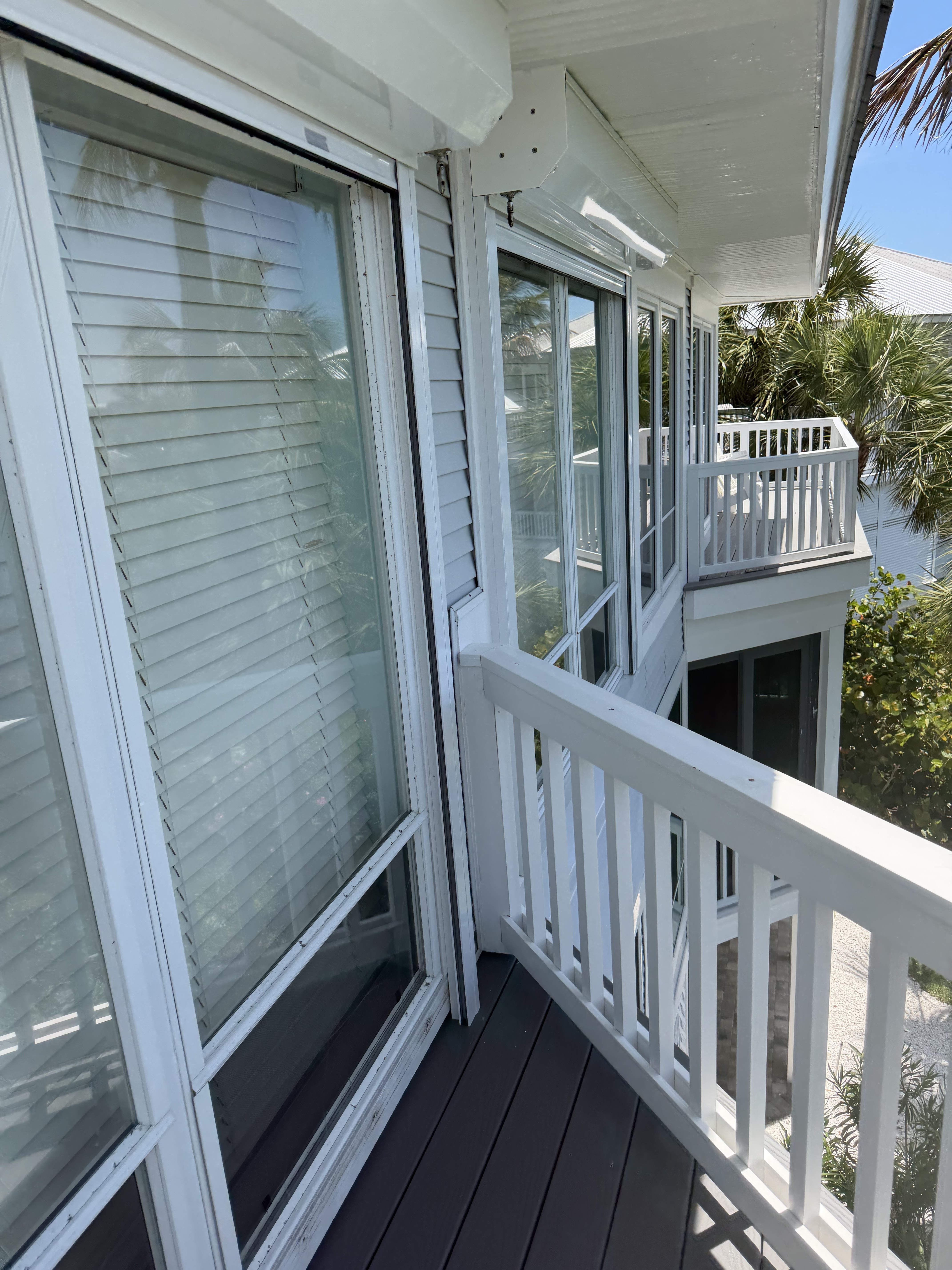 Exterior windows and sliders — clear glass and white frames.