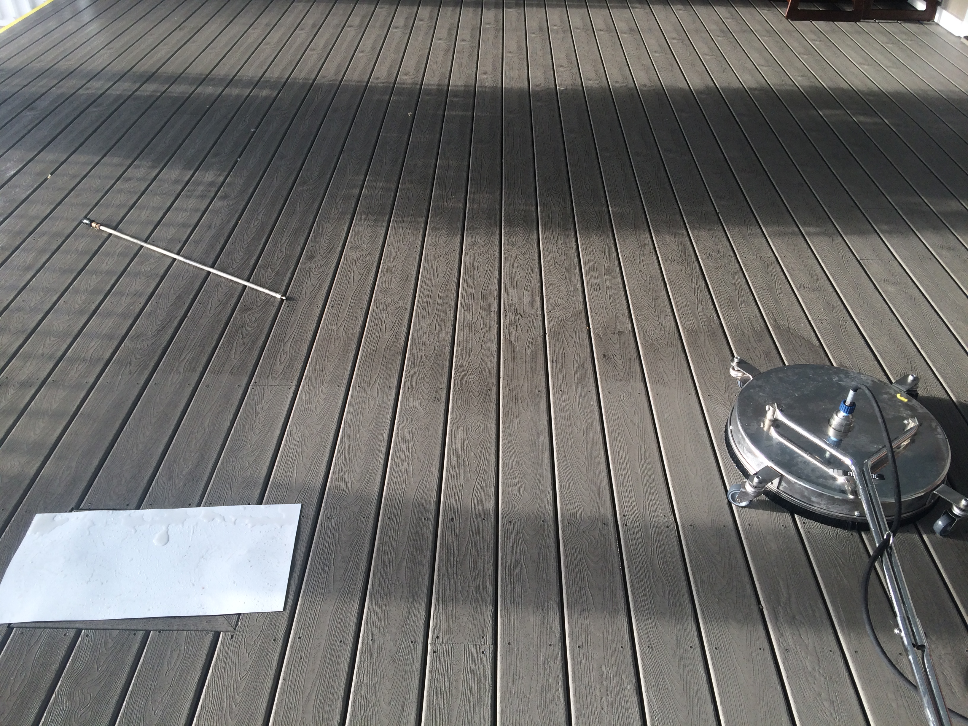 Marina or commercial deck — surface cleaning on exterior planking.