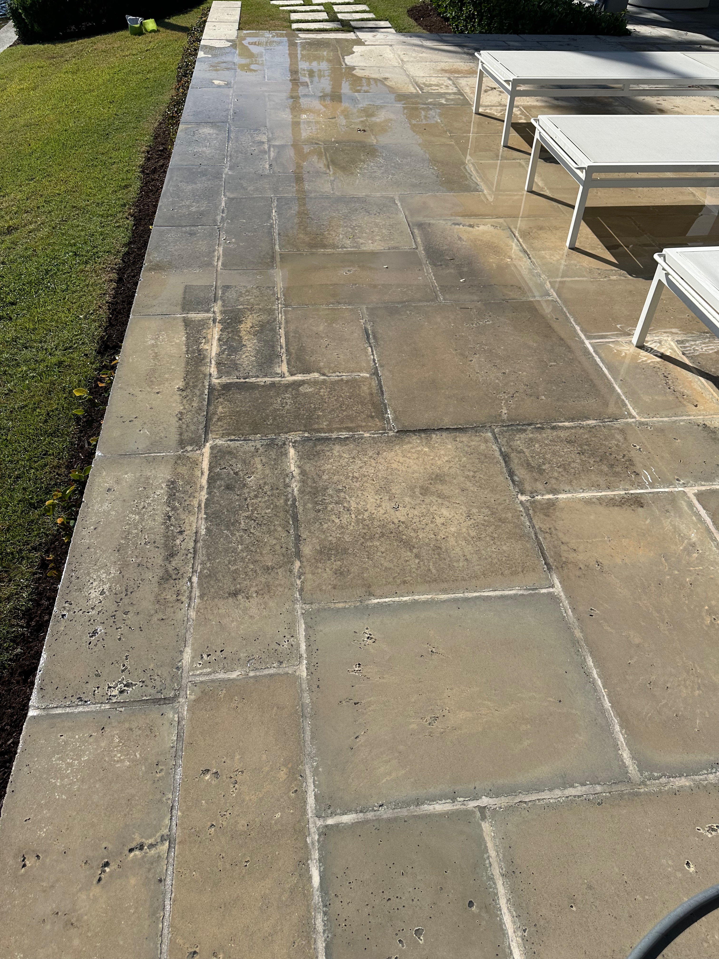 Pool deck and stone patio — rinsed pavers and outdoor living hardscape.